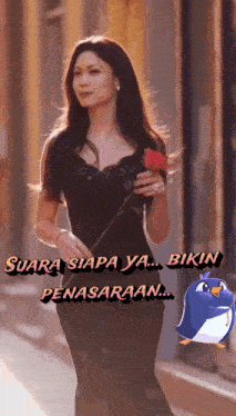 a woman in a black dress is holding a red rose with the words suara siapa ya bikin penasaran behind her