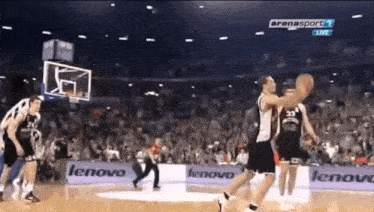 a basketball game is being played in front of a lenovo advertisement