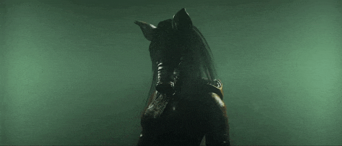 a silhouette of a person in a dark room with a large mouth