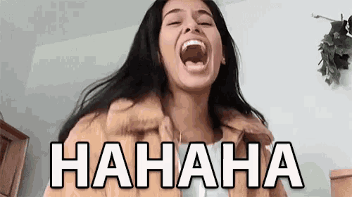 a woman is laughing with her mouth wide open and the word hahaha is on the screen