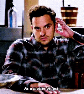 a man in a plaid shirt is sitting at a table and saying as a matter of fact