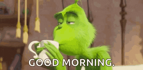 grinch is drinking from a cup and saying `` good morning '' .