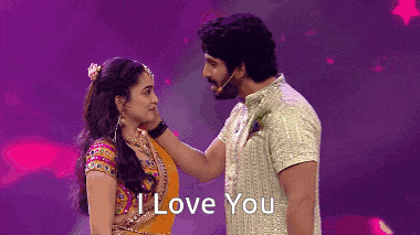 a man touching a woman 's face with the words " i love you " behind them