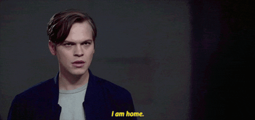 a man says " i am home " in a dark room