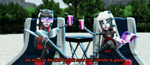 two monster high dolls are sitting on a beach talking