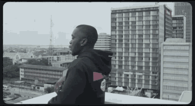 a man wearing a black hoodie with the word hoody on the back