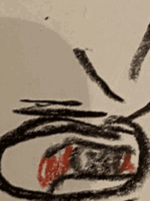 a close up of a child 's drawing of a person 's face with a red nose .