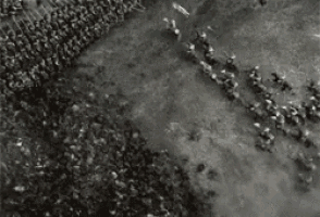 an aerial view of a large group of soldiers standing in a circle on the ground .