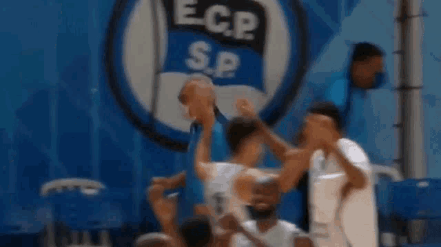 a blurry picture of a basketball game with a logo for ecp sp