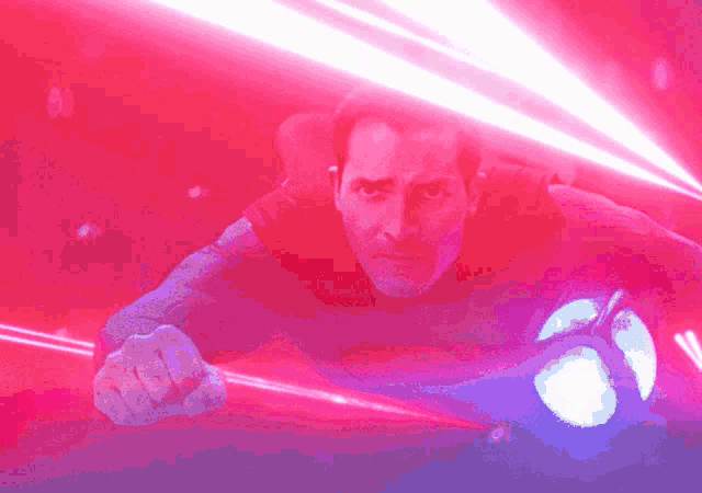 a man in a black shirt is surrounded by red light