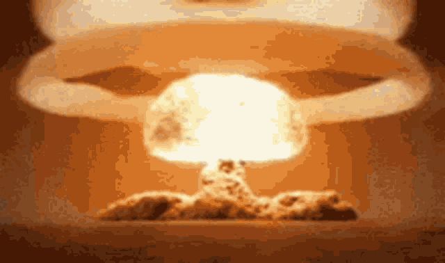 a close up of a nuclear explosion with smoke coming out of it .