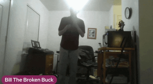 a man in a red shirt is standing in a room with bill the broken buck written on the bottom right