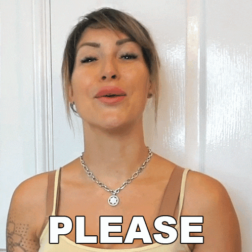 a woman wearing a necklace says please in front of a white wall