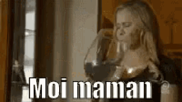 a woman is drinking a glass of wine and the words moi maman are above her