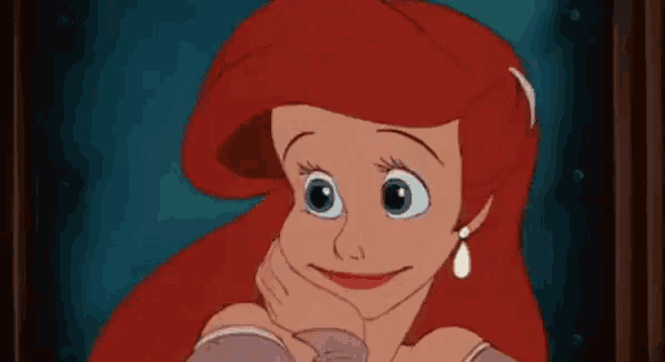 ariel from the little mermaid is smiling with her hand on her chin and wearing earrings .