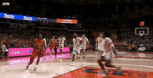a basketball game is being played in a stadium with espn in the corner