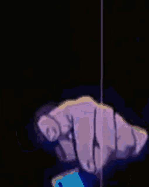 a person holding a cell phone in their hand with a blue light behind them