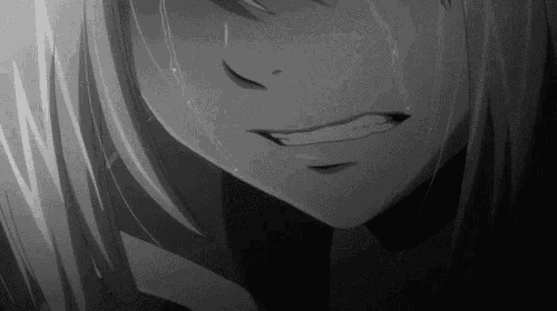 a black and white photo of a girl crying with tears coming down her face .