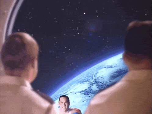 a man in a superman costume stands in front of a globe