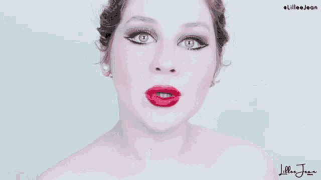 a woman with red lips and blue eyes is making a funny face