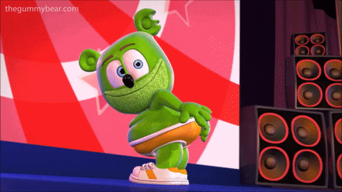 a gummy bear is standing on a stage in front of speakers with the website thegummybear.com at the bottom