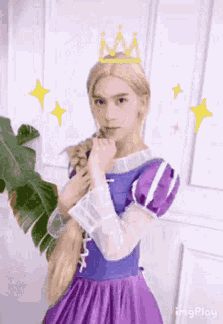 a man is dressed as rapunzel with a crown on his head and holding a plant .