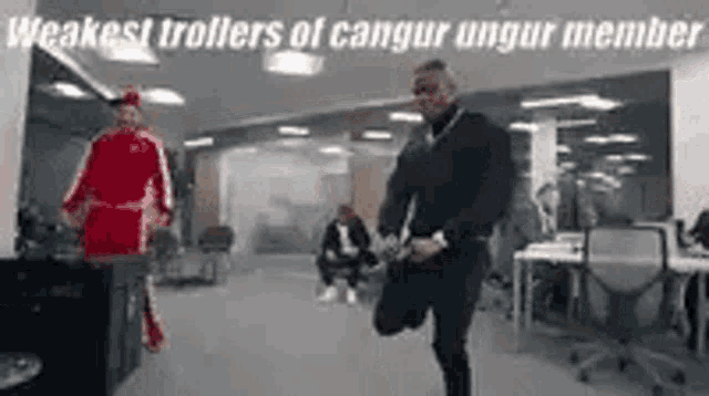 a man is stretching his legs in an office with a caption that says `` weakest trollers of cangur ungur member '' .
