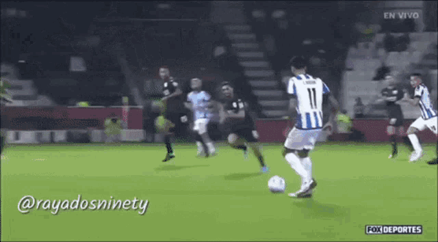 a soccer player with the number 11 on his jersey kicks the ball