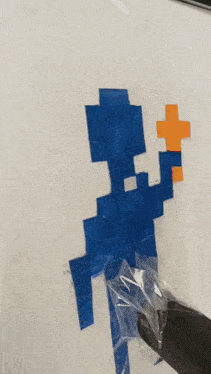 a pixel art of a person holding a cross in their hand