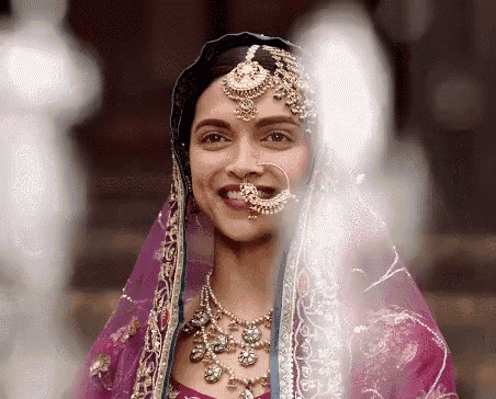 a close up of a woman wearing a veil and a nose ring