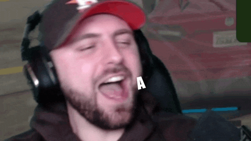 a man with a beard is wearing headphones and a hat with a star on it