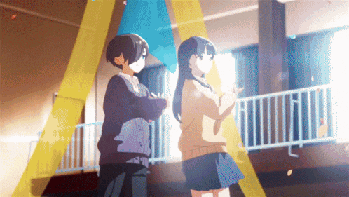 two anime characters standing next to each other in a room