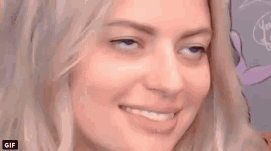 a close up of a woman 's face with a smile on it .