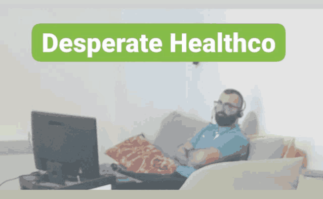 a man sits on a couch in front of a computer with the words desperate healthco on the bottom
