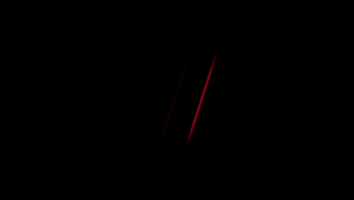 a close up of a red neon sign with a black background