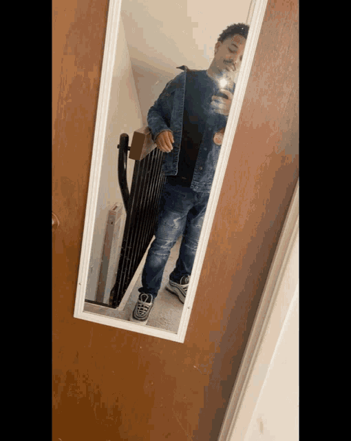 a man taking a selfie in a mirror with his phone
