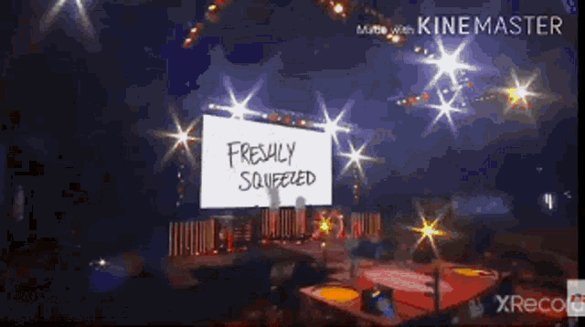 a sign that says freshly squeezed is on a stage