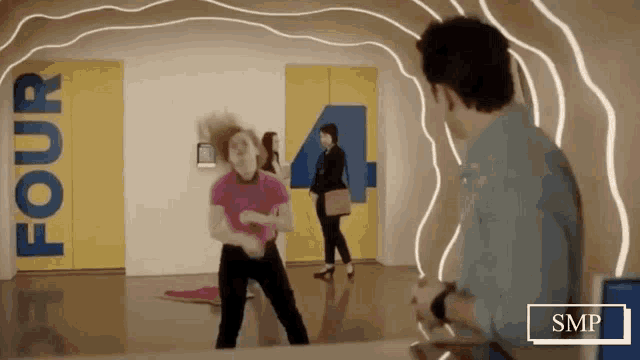 a woman is dancing in a hallway with a sign that says four