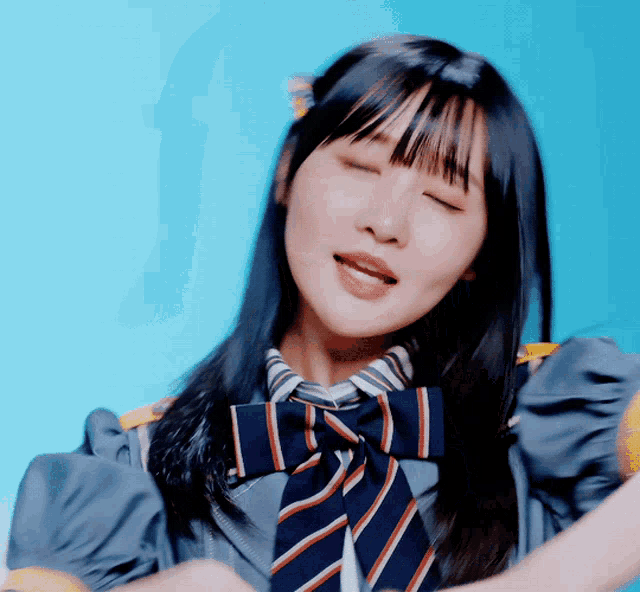 a girl with her eyes closed and a striped tie on