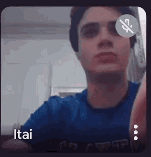 a man in a blue shirt is taking a picture of himself .