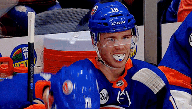 a hockey player wearing a helmet that says ccm on it