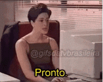 a woman is sitting at a desk in front of a computer with the word pronto on the screen .