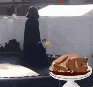 a statue of darth vader is standing next to a plate of food
