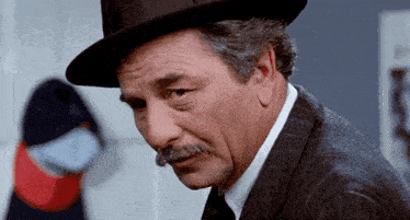 a man with a mustache wearing a hat