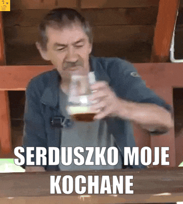 a man drinking from a glass with the words serduszko moje kochane written below him