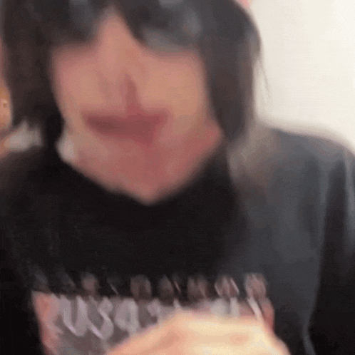 a close up of a person wearing sunglasses and a t-shirt with the word russia on it .