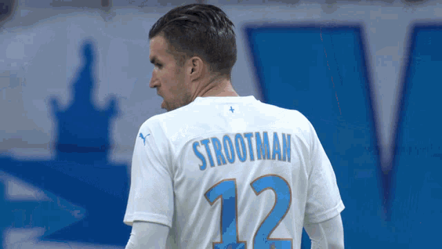 a man wearing a white shirt with the name strootman on the back