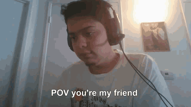 a man wearing headphones with the words pov you 're my friend