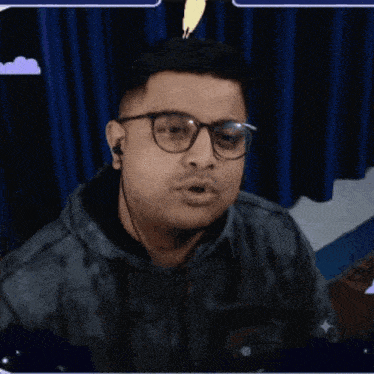 a man wearing glasses and a black jacket is dancing