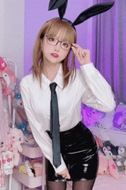 a woman wearing bunny ears and glasses is standing in a room